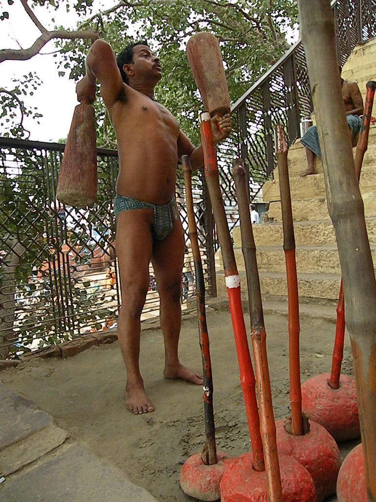 A wrestler training on the earth floor of a traditional Indian akhada
