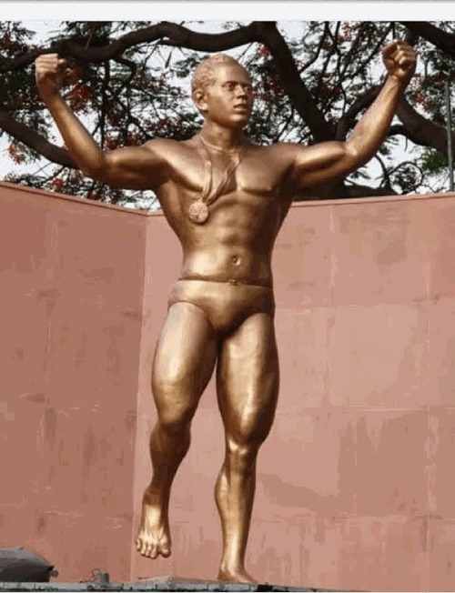 The statue of Khashaba Jadhav — arms lifted in the wrestler's salute, the Olympic medal at his chest